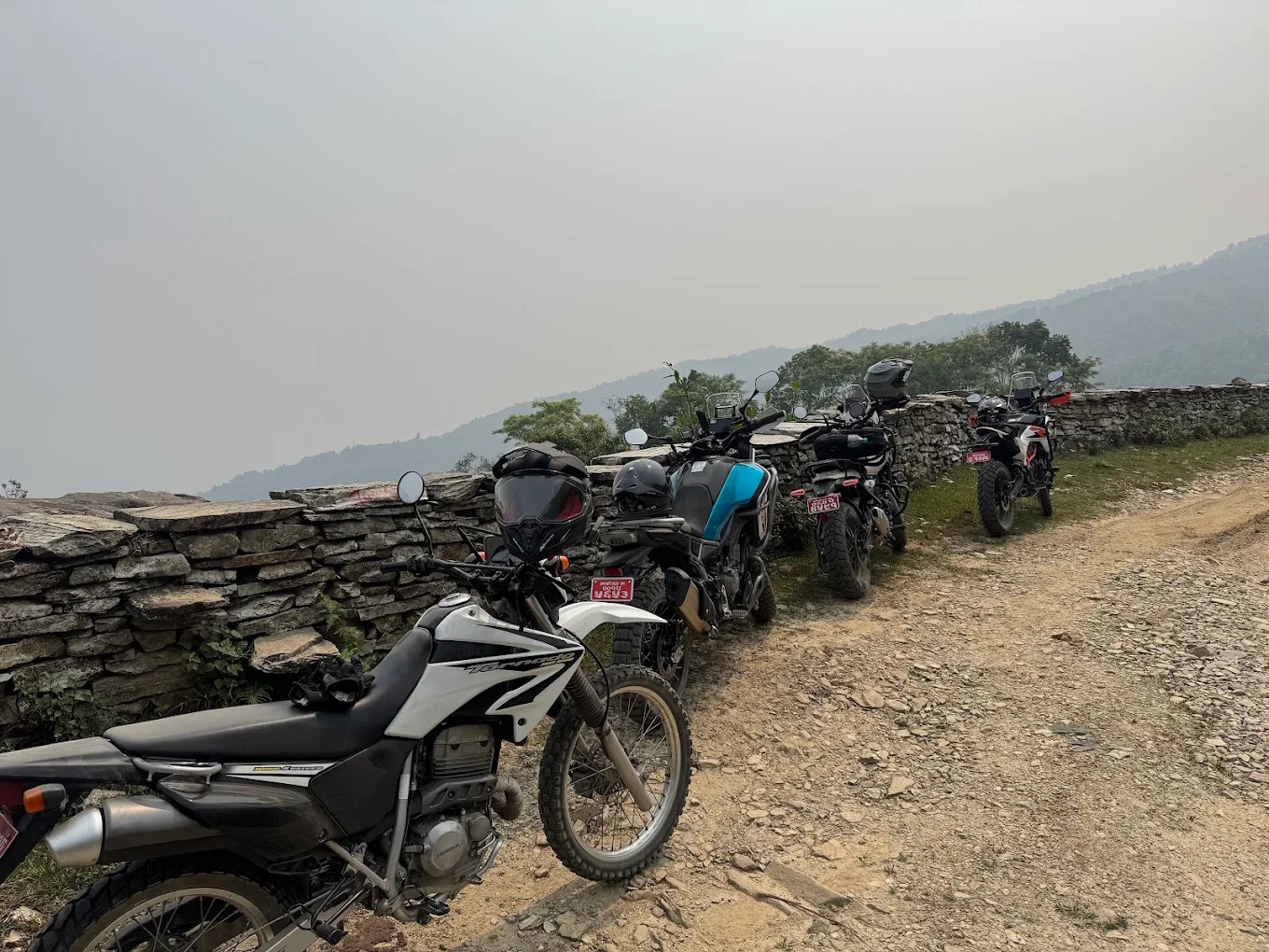 Adventure motorcycles parked beside a mountain trail